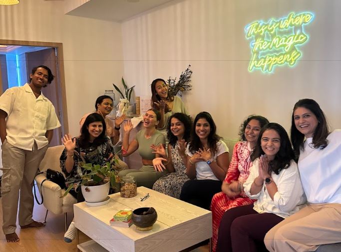 Wellness practitioners networking and connecting in a cozy studio space at Prana House, Dubai – building community, sharing ideas, and growing their practice